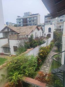 a view from a balcony of a building with a garden at Cómoda habitación independiente Miraflores in Lima