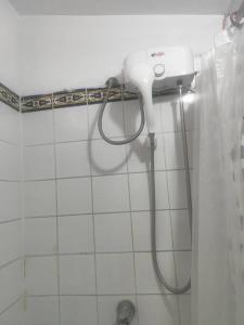 a shower in a bathroom with a hose on the wall at Cómoda habitación independiente Miraflores in Lima