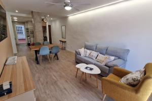 a living room with a couch and a table at Céntrico y amplio piso en Béjar in Béjar