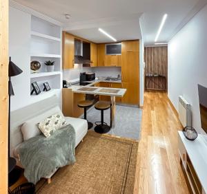 a living room with a white couch and a kitchen at Las Terrazas de Vigo - Paula in Vigo