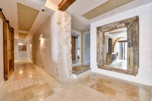 a hallway with white walls and a large mirror at Maison Salva - Hotel Boutique in Altea