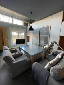 a living room with a table and two couches at Loft acogedor in Seville
