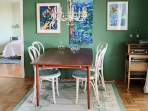 a dining room with a wooden table and chairs at 9 person holiday home in Skummeslövsstrand in Skummeslövsstrand