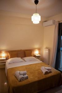 a bedroom with a large bed with towels on it at Υπέροχο διαμέρισμα με πάρκινγκ in Larisa +66 photos
