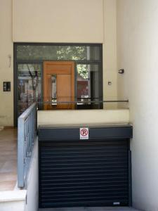 a building with a garage door with a no parking sign at Υπέροχο διαμέρισμα με πάρκινγκ in Larisa
