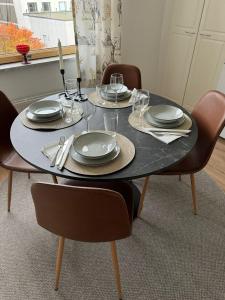 a dining room table with plates and glasses on it at Arctic Jaakko Suite in Rovaniemi