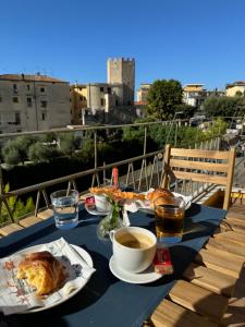 a table with food and drinks on a balcony at RoSea B&B Formia in Formia
