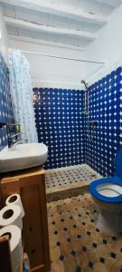 a blue bathroom with a toilet and a sink at Moroccan Riad With Panoramic Sea View in Essaouira +37 photos