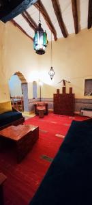 a large living room with a red rug at Moroccan Riad With Panoramic Sea View in Essaouira