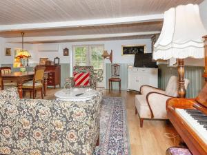 a living room with a couch and a piano at 4 person holiday home in Læsø-By Traum in Læsø