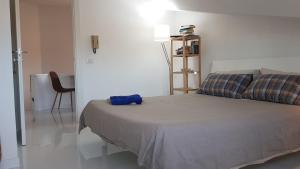 a bedroom with a bed with a blue bag on it at Roma - Casalpalocco - Amipsia in Casal Palocco