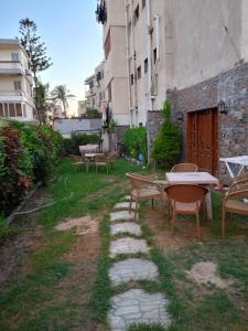 d'une terrasse avec des tables et des chaises dans la cour. dans l'établissement The best deserve the best, à Alexandrie