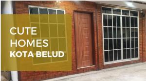 a sign on the side of a brick building at CuteHomes KB in Kota Belud