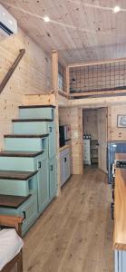 a room with wooden walls and stairs in a cabin at Lot 7 Tiny Home on the River in Cosby +23 photos