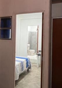 a bedroom with a bed and a bathroom with a tub at Casa Luna Bonita in Cabo San Lucas