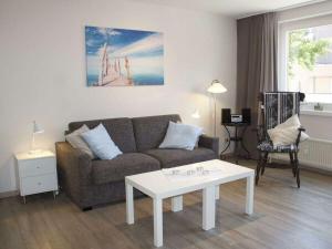 a living room with a couch and a table at Strandläufer Comfortable holiday residence in Wyk auf Föhr