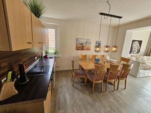 a kitchen and dining room with a table and chairs at Raphael - "Marilyn Monroe" in Timmendorfer Strand