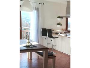 a living room with a table and a kitchen at Tromm - Blick Comfortable holiday residence in Rimbach