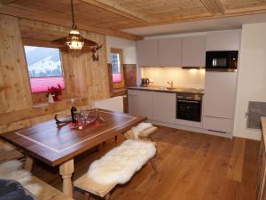 a kitchen with a wooden table in a room at Jogglelerhof Comfortable holiday residence in Finkenberg