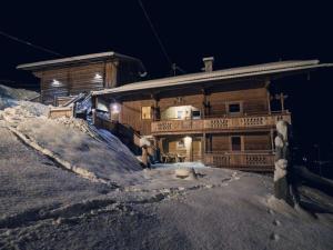 a house on top of a snow covered mountain at Jogglelerhof Comfortable holiday residence in Finkenberg
