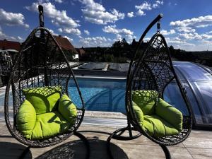a couple of chairs sitting next to a pool at Schlossblick Braunfels in Braunfels