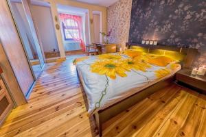 a bedroom with a large bed with a flower on it at Apartament Prestige Opole Centrum z garażem in Opole
