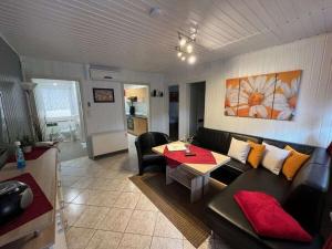 a living room with a couch and a table at Holiday house with 1 bedroom in Sewekow
