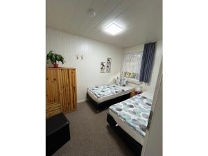 a bedroom with two beds and a window at Holiday house with 1 bedroom in Sewekow