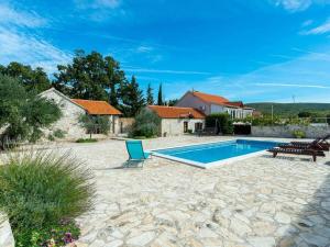a swimming pool in a yard with a house at Irena Comfortable holiday residence in Benkovac