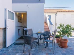 a patio with chairs and a table on a patio at Bianca Comfortable holiday residence in Sveti Filip i Jakov