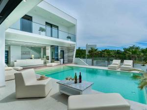 a villa with a swimming pool and a house at Luxury Villa Michele with heated pool in Jasenice