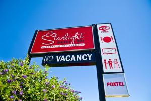 a sign for a restaurant and a sign for a pharmacy at Starlight Motor Inn in Roma