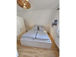 a bedroom with a bed with two pillows on it at Raphael - "Roger Moore" in Timmendorfer Strand