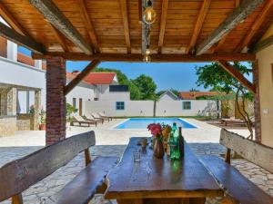 a wooden table with flowers on top of a patio at Marinic Comfortable holiday residence in Zadar