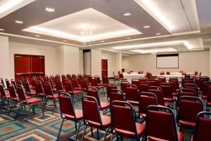 a conference room with chairs and a podium in it at Four Points by Sheraton Oklahoma City Quail Springs in Oklahoma City
