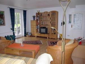 a living room with a couch and a tv at Brentel family Comfortable holiday residence in Vehlin
