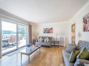 a living room with a couch and a table at Duck Bay Cottage 2 - Uk43935 in Balloch