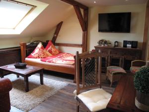 a living room with a bed and a flat screen tv at Pension Appartementhaus Central in Nordhausen