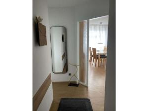 a room with a mirror and a dining room at 101 in the Vitamar holiday park in Dorum