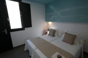 Postel nebo postele na pokoji v ubytování La Pasajera Hostal Boutique