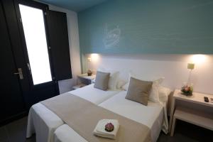 Postel nebo postele na pokoji v ubytování La Pasajera Hostal Boutique