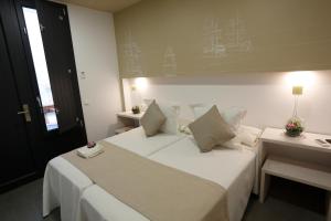 Postel nebo postele na pokoji v ubytování La Pasajera Hostal Boutique