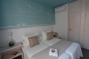 Postel nebo postele na pokoji v ubytování La Pasajera Hostal Boutique