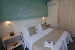 Postel nebo postele na pokoji v ubytování La Pasajera Hostal Boutique