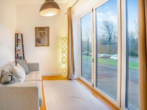 a living room with a large sliding glass door at Bay Cottage in Tondu
