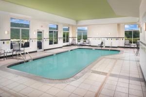 a pool in a hotel lobby with chairs and tables at Fairfield Inn & Suites Chattanooga I-24/Lookout Mountain in Chattanooga