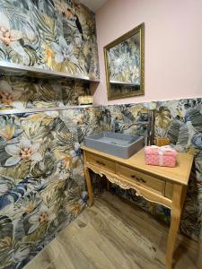 a bathroom with a sink and a floral wallpaper at Modern Central Sliema Loft Steps from the Beach in Sliema
