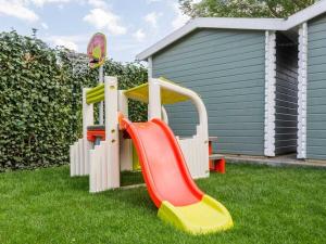 a playground with a slide in the grass at Holiday Home Traumzeit I in Zingst
