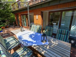 a patio with a table and chairs on a deck at Raphael - "Elvis Presley" in Timmendorfer Strand