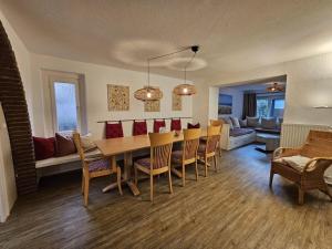 a dining room and living room with a table and chairs at Raphael - "Elvis Presley" in Timmendorfer Strand